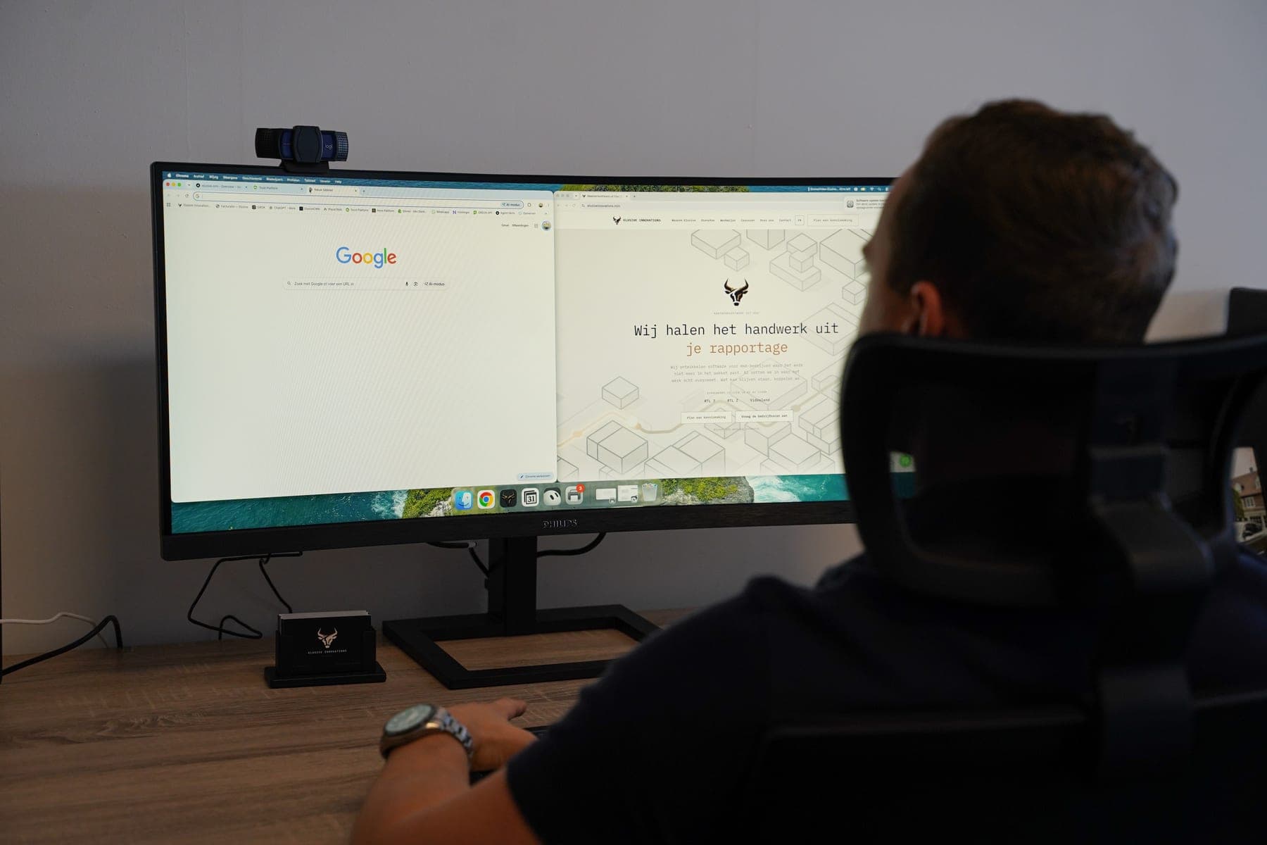 Wide monitor with Google search on the left and the Elusive website on the right, a team member watches from his chair
